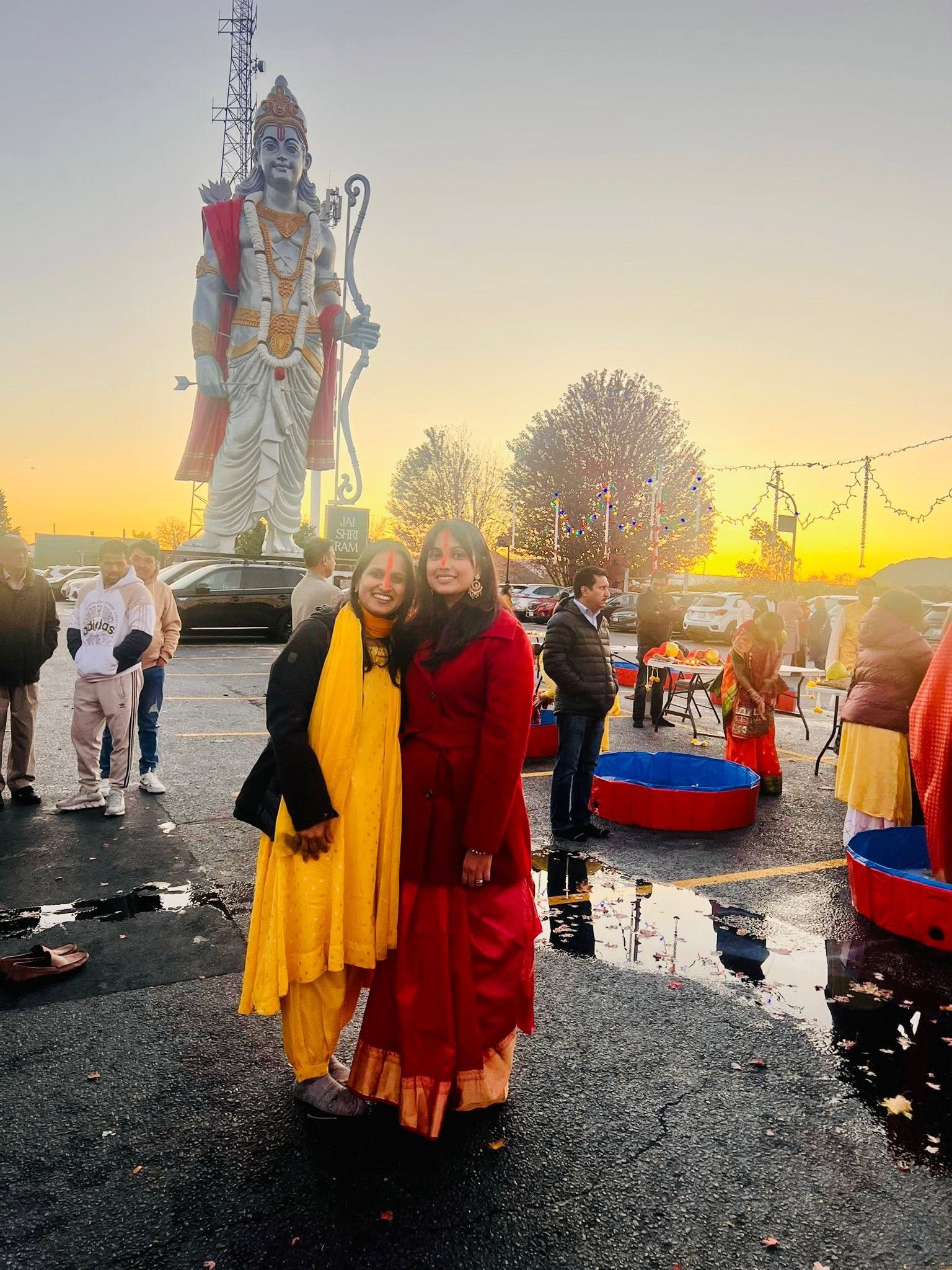A Vrati at sunrise in front of the Lord Ram statue at Usha Arghya