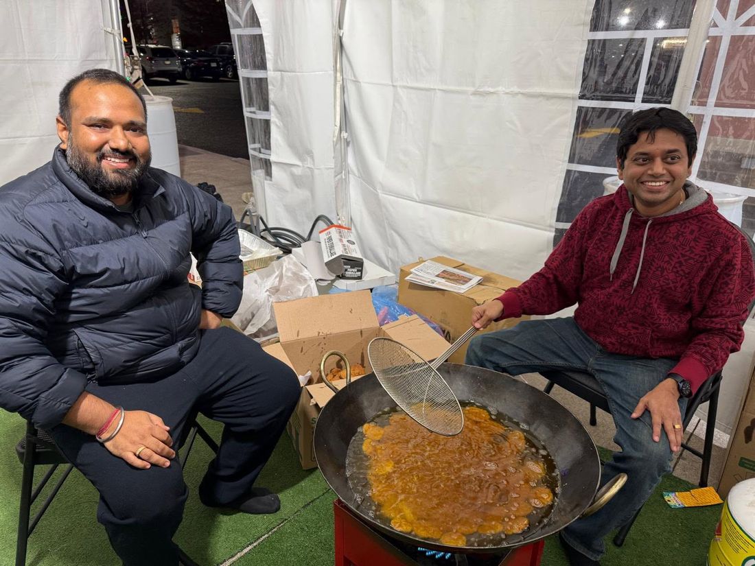 A volunteer frying Thekua in the BAJCCA tent